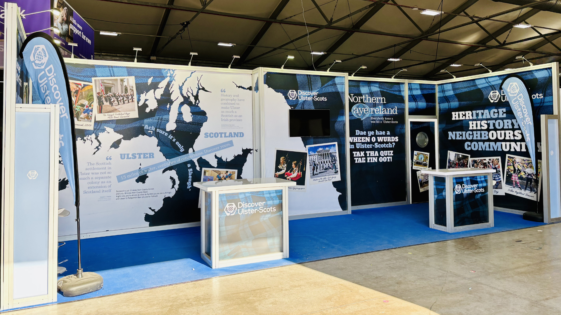 Exhibition booth featuring large map of Ulster and Scotland with informational displays about shared heritage and history.