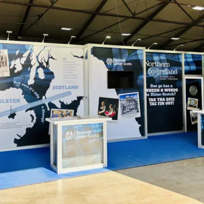 Exhibition booth featuring large map of Ulster and Scotland with informational displays about shared heritage and history.