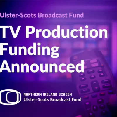 Against a purple background is an announcement of TV production funding by the Ulster-Scots Broadcast Fund with a remote control in someone's hand in the bottom right of image.