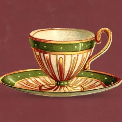 Vintage porcelain teacup with green and gold accents resting on a matching saucer against a maroon background.